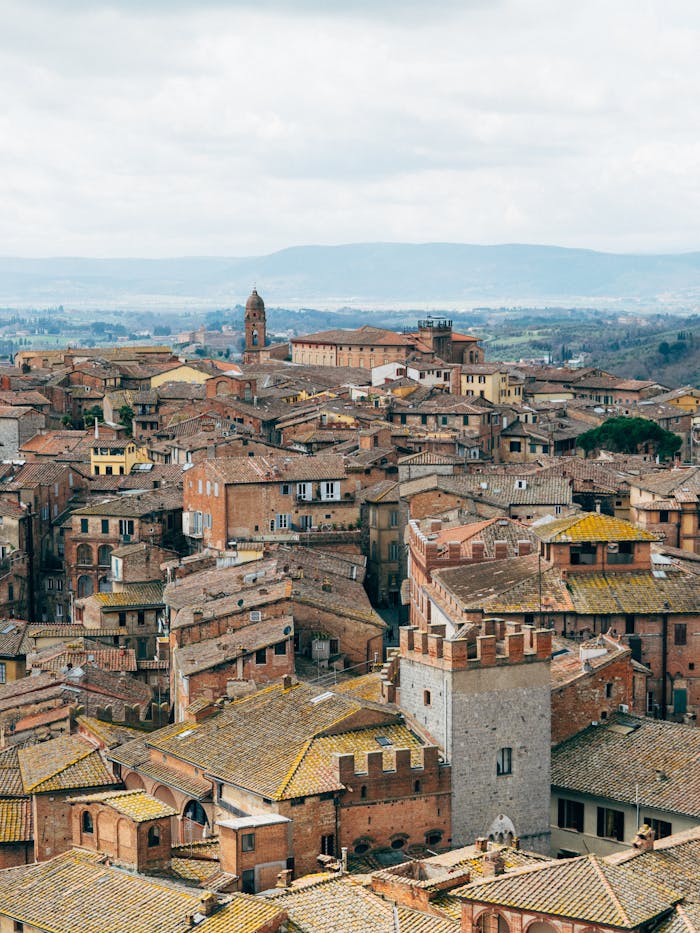 Panoramic view of Siena's old town with historic rooftops, Italy.