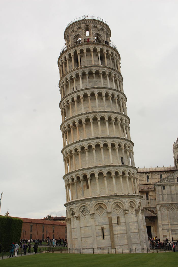 The famous Leaning Tower of Pisa in Italy captured on a cloudy day, showcasing its unique tilt.